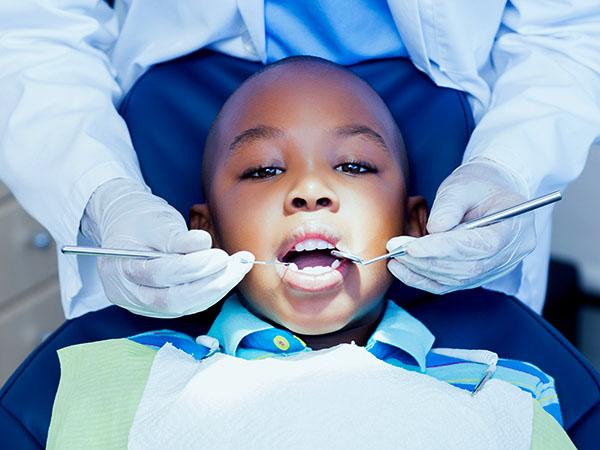 Young boy undergoing dental hygiene treatment